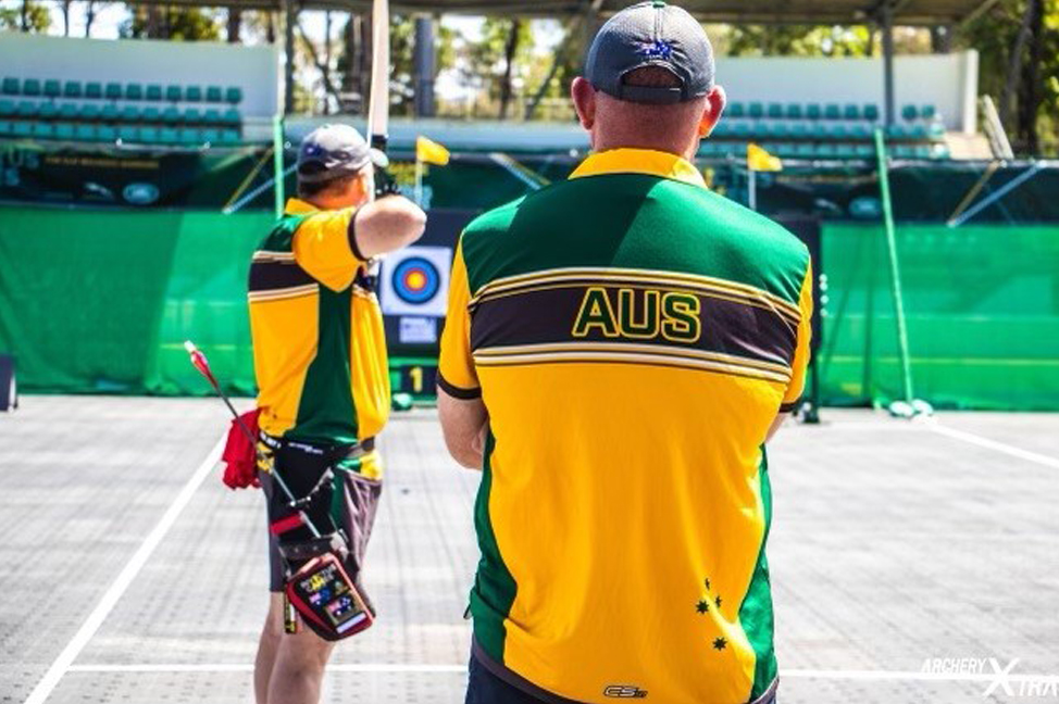 Former Invictus Pathways Program participant, Darren Peters, with the red shirt in his pocket while he's shooting an arrow