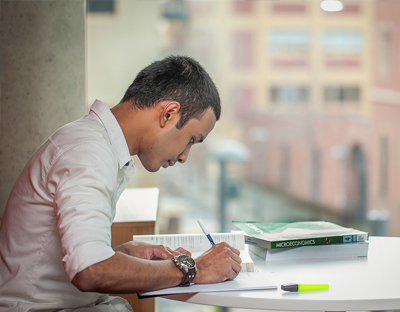 Male UniSA student studying at a desk